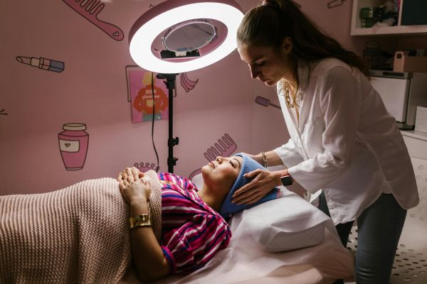 Woman receiving a relaxing facial treatment at a spa, promoting self-care and relaxation indoors.