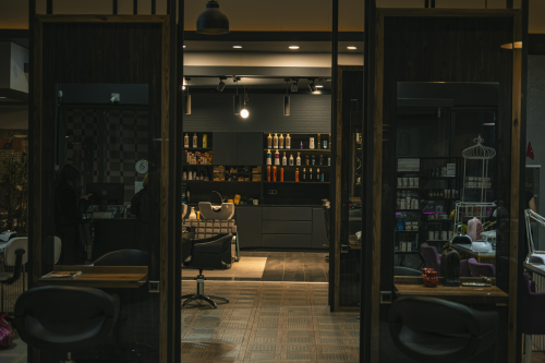 Cozy and stylish hair salon with modern decor and warm lighting, captured at night.